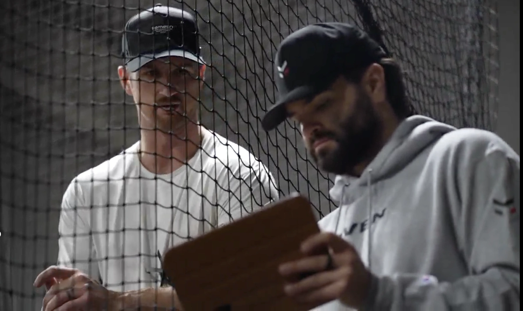 A Maven coach reviewing assessment data with a pitcher