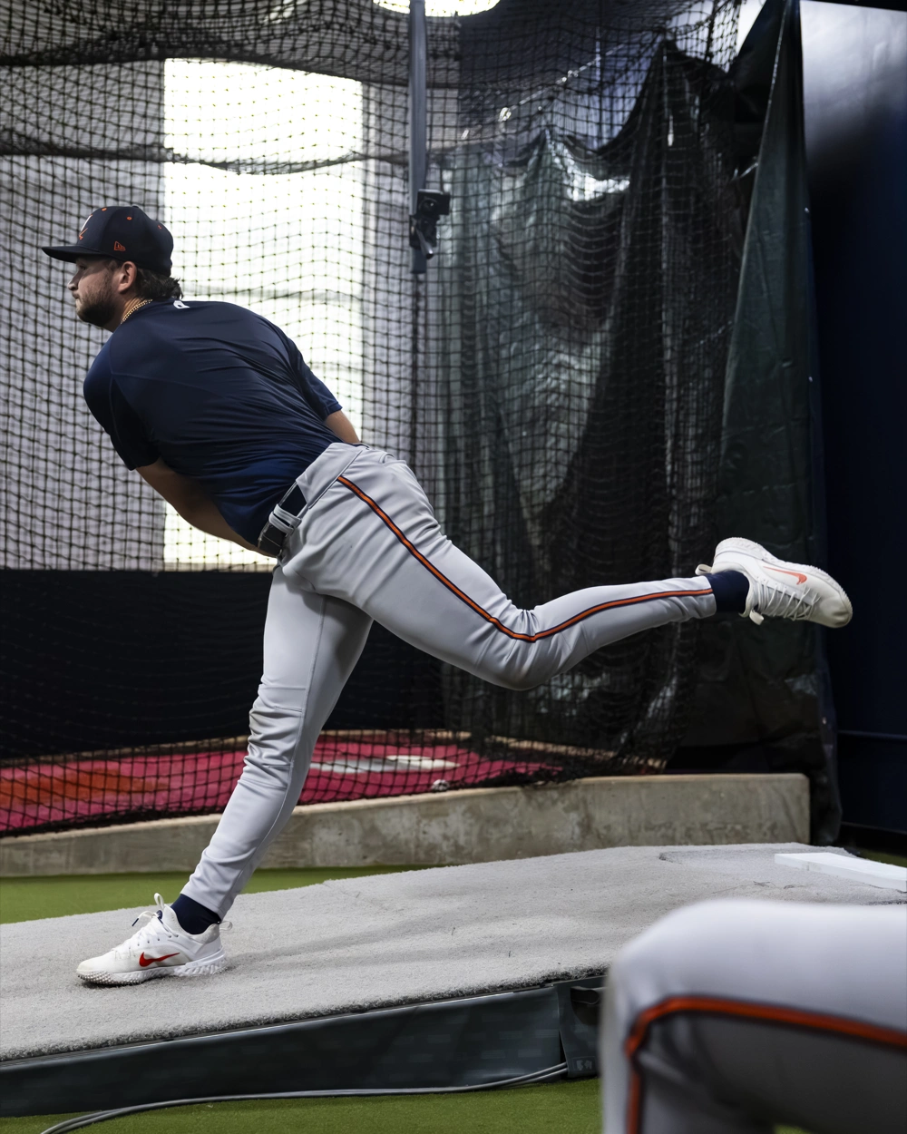 A pitcher finishing his delivery on the mound in the Charlottesville lab